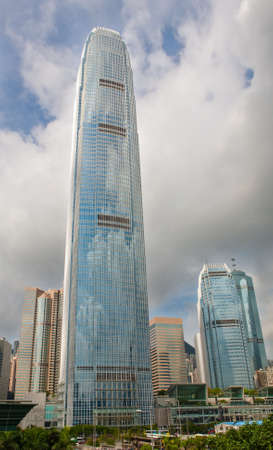 Extremely tall skyscraper in the financial district of Hong Kong on a cloudy day
