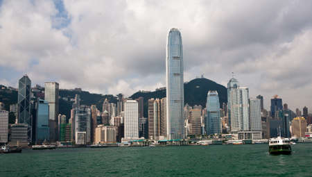 Hong Kong Island skyscrapers on a cloudy day with the harbor in the foreground