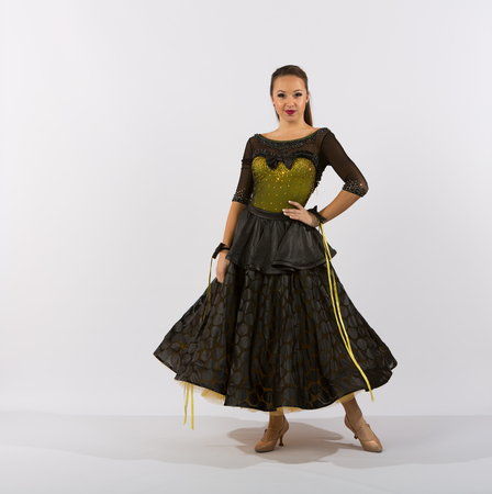 Young female ballroom dancer in studio taken against a high-key white backgroundの写真素材