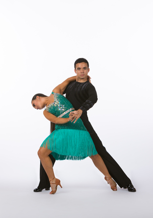 Two young ballroom dancers in studio taken against a high-key white backgroundの写真素材