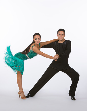 Two young ballroom dancers in studio taken against a high-key white backgroundの写真素材
