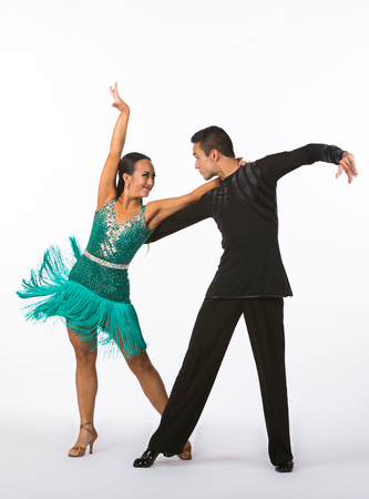 Two young ballroom dancers in studio taken against a high-key white backgroundの写真素材