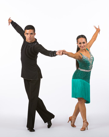 Two young ballroom dancers in studio taken against a high-key white backgroundの写真素材