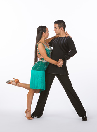 Two young ballroom dancers in studio taken against a high-key white backgroundの写真素材