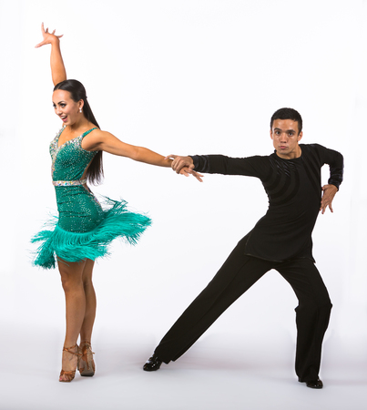 Two young ballroom dancers in studio taken against a high-key white backgroundの写真素材