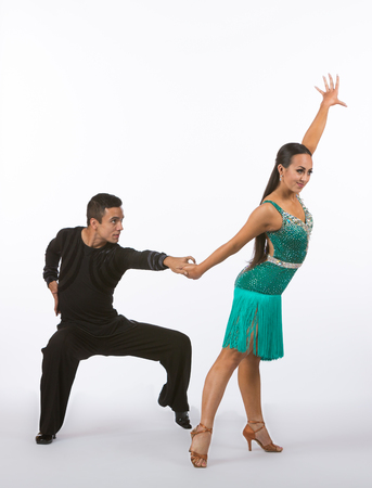Two young ballroom dancers in studio taken against a high-key white backgroundの写真素材