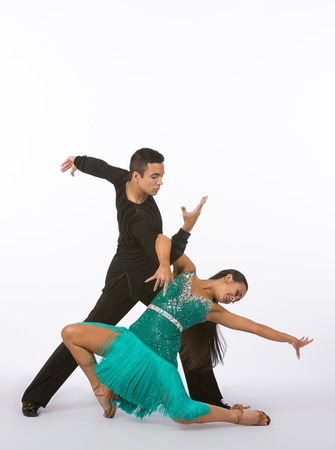 Two young ballroom dancers in studio taken against a high-key white backgroundの写真素材