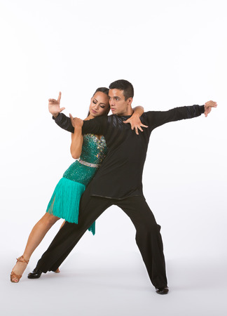 Two young ballroom dancers in studio taken against a high-key white backgroundの写真素材