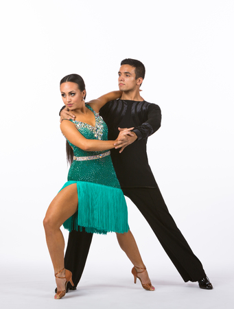Two young ballroom dancers in studio taken against a high-key white backgroundの写真素材