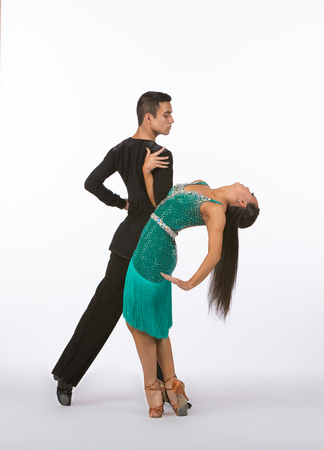 Two young ballroom dancers in studio taken against a high-key white backgroundの写真素材