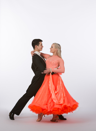 Two young ballroom dancers in studio taken against a high-key white backgroundの写真素材