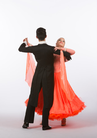 Two young ballroom dancers in studio taken against a high-key white backgroundの写真素材