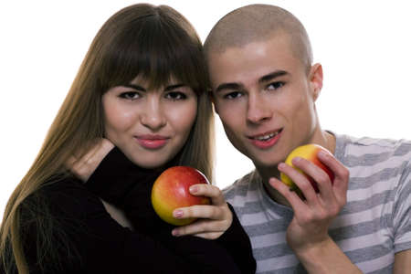 beautiful young couple with apples in a handの写真素材