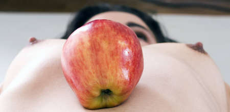 pretty girl and apple. studio survey with make-upの写真素材