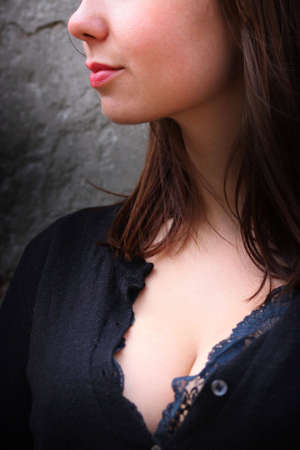 Lips and a breast. A female street portraitの写真素材