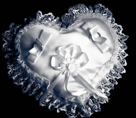 Wedding rings on a small pillowの写真素材