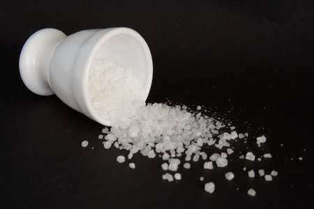 Split salt on the black backgroundの写真素材