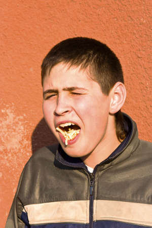 The guy eating fried potatoes
