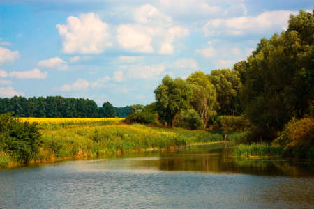 Countryside landscape with small lake and sky