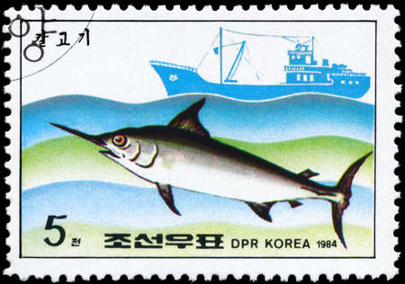 NORTH KOREA - CIRCA 1984: A Stamp printed in NORTH KOREA shows image of a Swordfish and Trawler from the series "Fishing Industry", circa 1984の写真素材