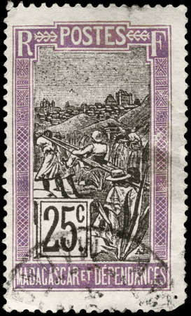 MADAGASCAR - CIRCA 1922: A Stamp printed in MADAGASCAR shows the Transportation by Sedan Chair, circa 1922の写真素材