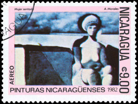 NICARAGUA - CIRCA 1982: A Stamp printed in NICARAGUA shows the lithography "The Sitting Woman" of the artist Armando Morales, from the series "Paintings", circa 1982の写真素材