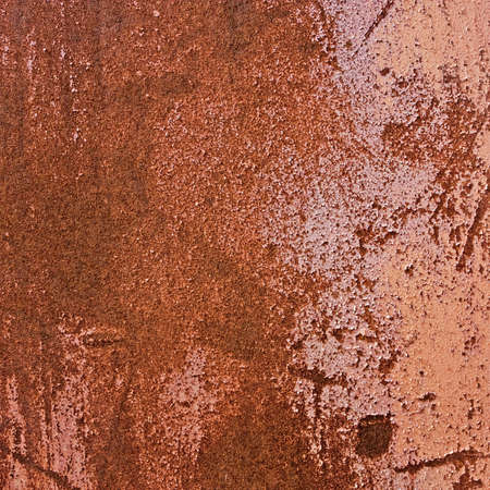 The rusty surface in the background