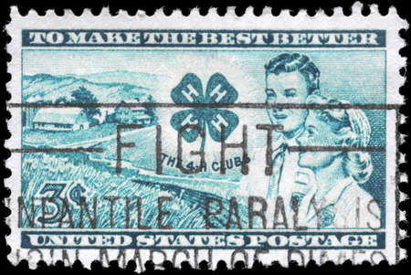 USA - CIRCA 1952: A Stamp printed in USA shows the Farm, Club emblem, Boy and Girl, 4-H Club Issue, circa 1952のeditorial素材