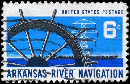 USA - CIRCA 1968: A Stamp printed in USA shows the Ships Wheel, Power Transmission Tower & Barge, Arkansas River Navigation Issue, circa 1968のeditorial素材