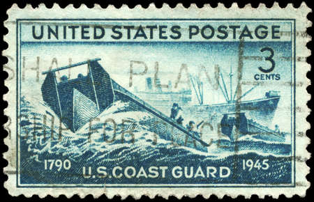 USA - CIRCA 1945: A Stamp printed in USA shows the Coast Guard landing Craft and supply Ship, achievements of the US Coast Guard in WWII, circa 1945の写真素材