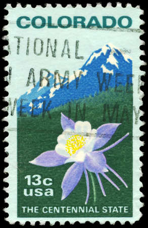 USA - CIRCA 1977: A Stamp printed in USA shows the Columbine & Rocky Mountains, Colorado Statehood issue, circa 1977の写真素材