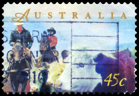 AUSTRALIA - CIRCA 1998: A Stamp printed in AUSTRALIA shows the Herding Cattle on Horseback, Farming series, circa 1998のeditorial素材