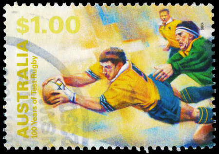 AUSTRALIA - CIRCA 1999: A Stamp printed in AUSTRALIA shows the Diving with ball, 100 Years of Test Rugby, series, circa 1999のeditorial素材