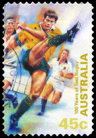 AUSTRALIA - CIRCA 1999: A Stamp printed in AUSTRALIA shows the Kicking ball, 100 Years of Test Rugby, series, circa 1999のeditorial素材