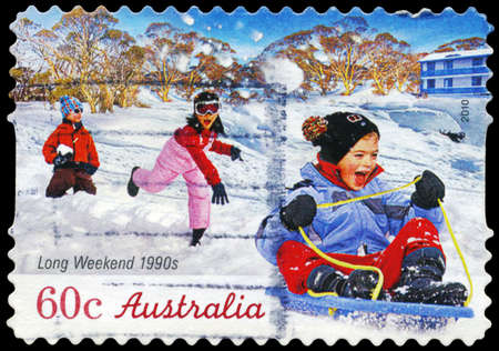 AUSTRALIA - CIRCA 2010: A Stamp printed in AUSTRALIA shows the playing Children, Long Weekend series, circa 2010のeditorial素材