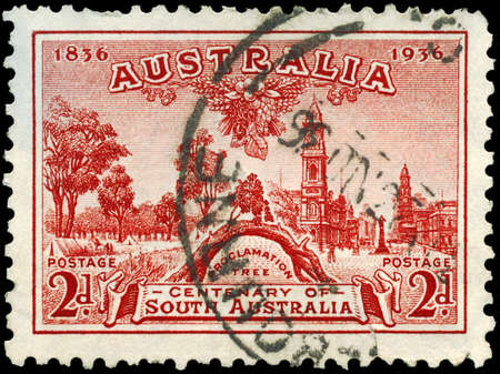 AUSTRALIA - CIRCA 1936: A Stamp printed in AUSTRALIA shows the Old Gum Tree, Glenelg River, King William Street, Adelaide, Centenary of South Australia, circa 1936のeditorial素材