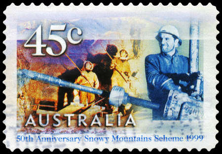AUSTRALIA - CIRCA 1999: A Stamp printed in AUSTRALIA shows the Rock Bolters at Tumut 2 Power Station, Driller at Tooma-Tumut Tunnel, Snowy Mountains Scheme, 50th anniversary, series, circa 1999のeditorial素材