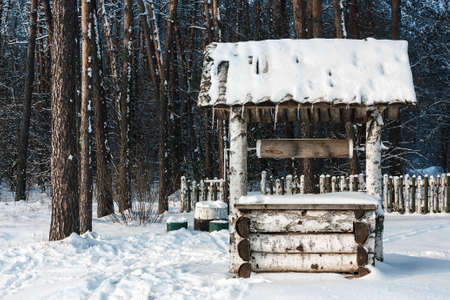 Landscape with the draw well on winter forest backgroundの写真素材