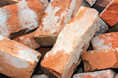 Pile of old red bricks on backgroundの写真素材