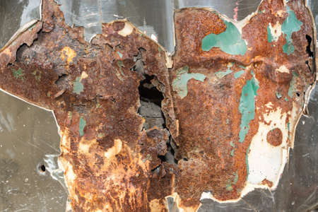 Abstract corroded surface of rusty holed metalの写真素材
