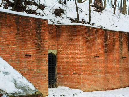 Winter landscape with brick wall and grating doorの写真素材