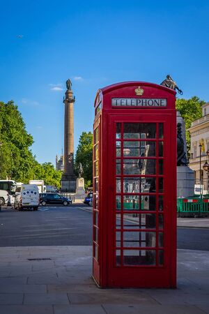 Red telephone box on neighborhood district of St. James in London, UKの写真素材
