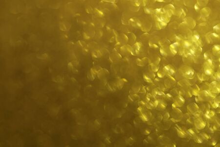Shiny gold abstract background with a bokeh effect の写真素材
