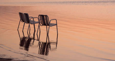 Three empty beach chairs on a lonely quite beach early in the morning. The location is at Hurghada, Egypt.の写真素材