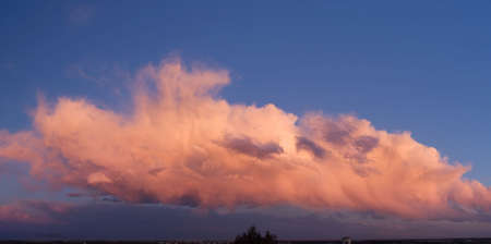 Panorama of a large clouds on sky with sunset lights. The is a panorama merge of 3 s.