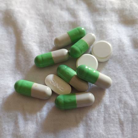 Text phrase Coronavirus on a green background with medicines and protective masks. Novel coronavirus 2019-nCoV, MERS-Cov middle East respiratory syndrome coronavirus.  Aの写真素材