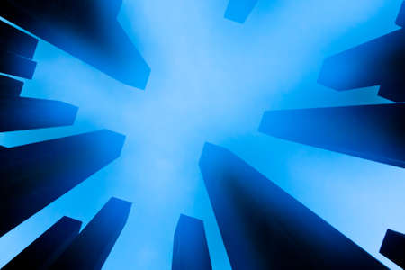 looking up skyscrapers in blue hour and fogの写真素材