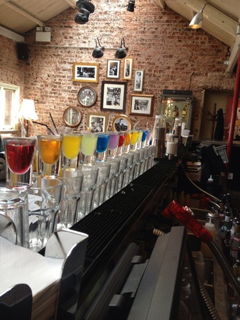 Vodka shots lined up by colour in loft spaceの素材