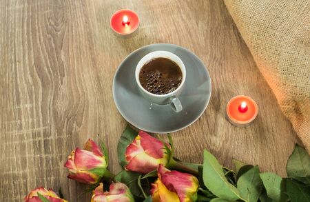 Fresh italian style coffee next to flower bouquetの写真素材