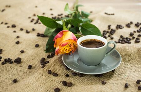 Fresh italian style coffee next to flower bouquetの写真素材